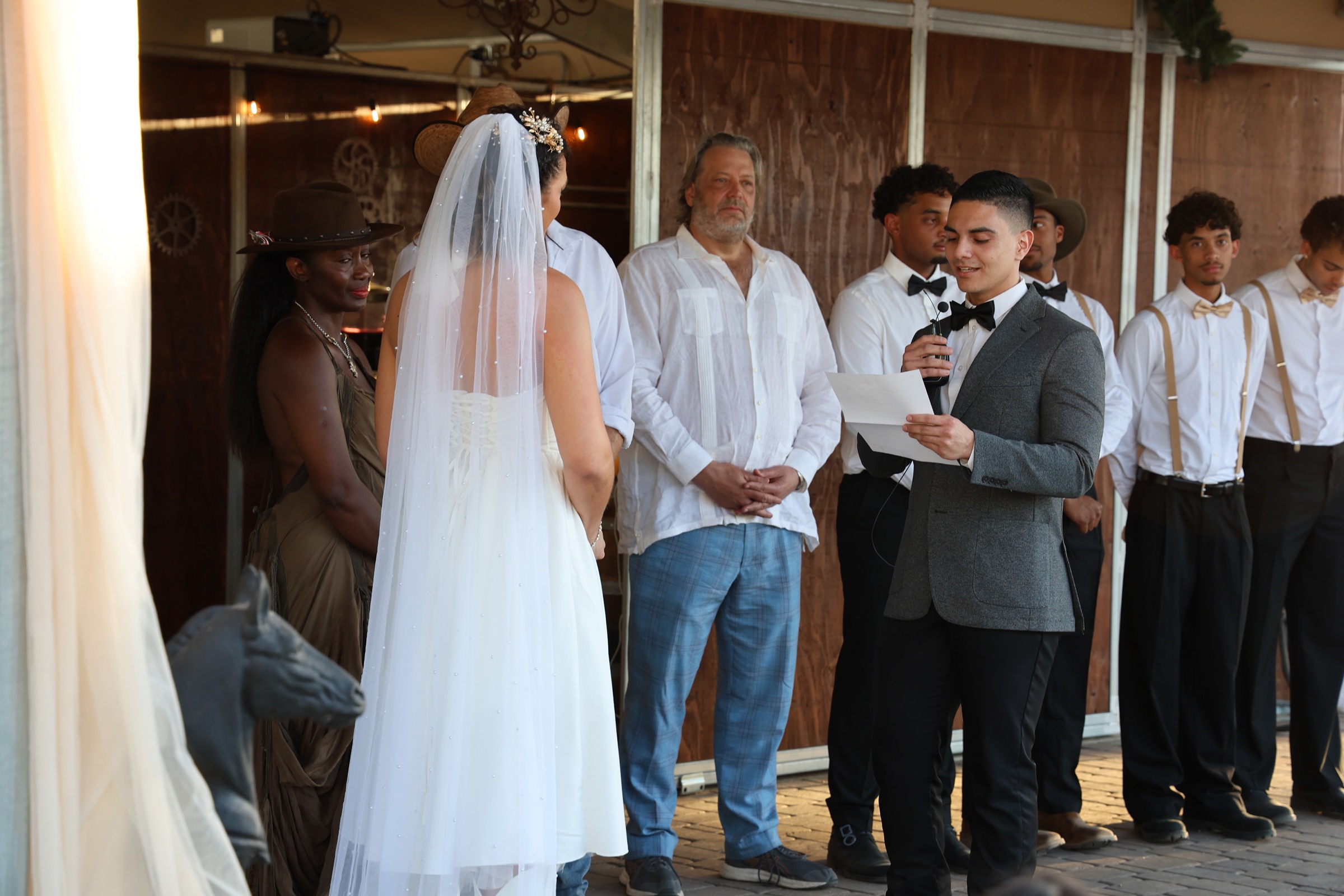 A wedding ceremony taking place inside the open-air barn at Lady Horse Ranch